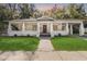 Charming home featuring a spacious front porch decorated with string lights and flowers at 907 Vistabula St, Lakeland, FL 33801