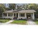 Charming single story home with a covered front porch, landscaped front yard, and driveway at 907 Vistabula St, Lakeland, FL 33801