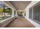 Inviting front porch with a swing, wood floors, overhead lighting and beautiful decorative columns at 907 Vistabula St, Lakeland, FL 33801