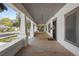 Inviting front porch with wood floors, decorative columns, overhead lighting, and a beautifully decorated front door at 907 Vistabula St, Lakeland, FL 33801