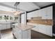 Bright kitchen with large island, marble countertops, and stylish pendant lighting at 907 Vistabula St, Lakeland, FL 33801