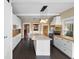 Open-concept kitchen with large island, stainless steel appliances, and custom cabinetry at 907 Vistabula St, Lakeland, FL 33801
