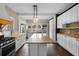 Spacious kitchen with an island, stainless steel appliances, and dark wood floors at 907 Vistabula St, Lakeland, FL 33801