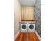 Laundry room featuring a side-by-side washer and dryer and patterned wallpaper at 907 Vistabula St, Lakeland, FL 33801