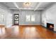 Living room featuring a decorative fireplace, crown moulding, and hardwood floors at 907 Vistabula St, Lakeland, FL 33801