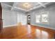 Bright living room boasts hardwood floors, coffered ceilings, and large windows at 907 Vistabula St, Lakeland, FL 33801