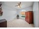 Bedroom with carpet, arched window, and dark wood furniture at 1017 Sawgrass Dr, Winter Haven, FL 33884