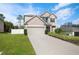 Charming two-story home with neutral paint, attached garage, manicured lawn, and beautiful landscaping at 1018 Roberta Rd, Lake Wales, FL 33853