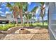 Backyard featuring a fire pit, seating area, landscaping, and water view at 105 Wyndham Dr, Winter Haven, FL 33884