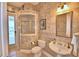 Elegant bathroom features a vanity sink, corner shower, and decorative wallpaper at 105 Wyndham Dr, Winter Haven, FL 33884