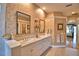 Bathroom featuring dual sinks, decorative wallpaper and large mirror at 105 Wyndham Dr, Winter Haven, FL 33884