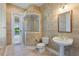 Bathroom with tiled walls, glass-enclosed shower, and a pedestal sink at 105 Wyndham Dr, Winter Haven, FL 33884