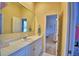 Bright bathroom with a large mirror, white vanity, and entry to bedroom at 105 Wyndham Dr, Winter Haven, FL 33884