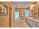 Elegant bathroom with a soaking tub, dual sinks, and decorative details at 105 Wyndham Dr, Winter Haven, FL 33884