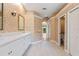 This bathroom features a double vanity with white cabinets and neutral wallpaper at 105 Wyndham Dr, Winter Haven, FL 33884