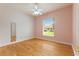 Comfortable bedroom with hardwood floors, neutral paint, a ceiling fan and a window for natural light at 105 Wyndham Dr, Winter Haven, FL 33884