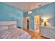 This bedroom has light hardwood flooring, an ensuite, and a walk-in closet at 105 Wyndham Dr, Winter Haven, FL 33884