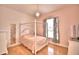 Serene bedroom with a four-poster bed, hardwood floors, and chandelier lighting at 105 Wyndham Dr, Winter Haven, FL 33884