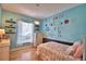 Decorated bedroom featuring a bed, shelving, and a bright ABC accent wall at 105 Wyndham Dr, Winter Haven, FL 33884