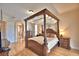 Bedroom featuring a beautiful canopy bed, wood floors, and classic decor at 105 Wyndham Dr, Winter Haven, FL 33884