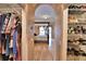 Open closet with clothing and shoes adjacent to bedroom with pool view at 105 Wyndham Dr, Winter Haven, FL 33884