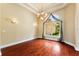 Elegant dining space with rich wood floors, decorative lighting, and a view of the lush outdoors at 105 Wyndham Dr, Winter Haven, FL 33884