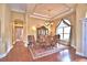 Formal dining room featuring hardwood floors, a large window, chandelier, and decorative rug at 105 Wyndham Dr, Winter Haven, FL 33884