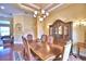 Elegant dining room with a classic chandelier, ornate china cabinet, and seating for six at 105 Wyndham Dr, Winter Haven, FL 33884