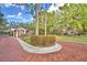 Welcome to Wyndham! Elegant entrance with brick features and manicured landscaping at 105 Wyndham Dr, Winter Haven, FL 33884