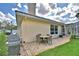 Paver patio with dining set, grill and access to pool, and screened-in porch at 105 Wyndham Dr, Winter Haven, FL 33884