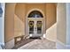 Close-up of a double-door entryway framed by arched windows and adorned with decorative wreaths at 105 Wyndham Dr, Winter Haven, FL 33884