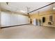 Spacious garage with epoxy floors, overhead storage racks, and ample cabinet space to keep everything organized at 105 Wyndham Dr, Winter Haven, FL 33884