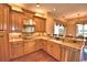 Gourmet kitchen showcasing granite countertops, wooden cabinets, and stainless steel appliances at 105 Wyndham Dr, Winter Haven, FL 33884