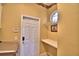 Functional laundry room featuring a storage shelf and a charming window, blending utility with cozy details at 105 Wyndham Dr, Winter Haven, FL 33884