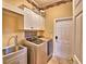 Well-equipped laundry room with modern washer, dryer, sink, and ample storage space at 105 Wyndham Dr, Winter Haven, FL 33884