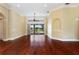 A bright, spacious living room featuring gleaming wood floors and a view of the outdoor pool area at 105 Wyndham Dr, Winter Haven, FL 33884