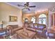 Open-concept living room with hardwood floors, leather sofas, and easy access to other rooms at 105 Wyndham Dr, Winter Haven, FL 33884