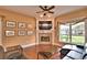 Cozy living room with a fireplace, large window, and comfortable seating at 105 Wyndham Dr, Winter Haven, FL 33884