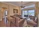Cozy living room featuring leather sofas, hardwood floors, and a large window overlooking the patio at 105 Wyndham Dr, Winter Haven, FL 33884
