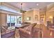 Spacious living room with comfortable seating, hardwood floors, and access to the screened patio at 105 Wyndham Dr, Winter Haven, FL 33884
