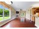 Bright living room with hardwood floors, fireplace, and large windows offering scenic outdoor views and ample natural light at 105 Wyndham Dr, Winter Haven, FL 33884