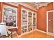Home office featuring built-in bookcases, a ceiling fan, and hardwood flooring at 105 Wyndham Dr, Winter Haven, FL 33884