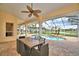 Covered patio boasting a table and chairs, and view of the pool and spa at 105 Wyndham Dr, Winter Haven, FL 33884