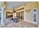 Covered patio featuring an outdoor dining set, ceiling fan, and sliding glass doors at 105 Wyndham Dr, Winter Haven, FL 33884