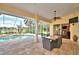 View of covered patio with dining set, along with the pool and water view at 105 Wyndham Dr, Winter Haven, FL 33884