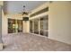 Covered patio with brick flooring, recessed lighting, and large sliding glass doors at 105 Wyndham Dr, Winter Haven, FL 33884