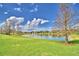 Lush lawn leading to the pond with fountain views at 105 Wyndham Dr, Winter Haven, FL 33884