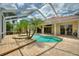 Enjoy the Florida lifestyle in this beautiful screened-in pool area with spa and multiple palm trees at 105 Wyndham Dr, Winter Haven, FL 33884