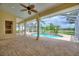 Screened-in lanai with brick flooring leading to a pool and spa at 105 Wyndham Dr, Winter Haven, FL 33884
