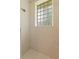 Tiled shower with rainfall shower head and a glass block window providing natural light at 105 Wyndham Dr, Winter Haven, FL 33884